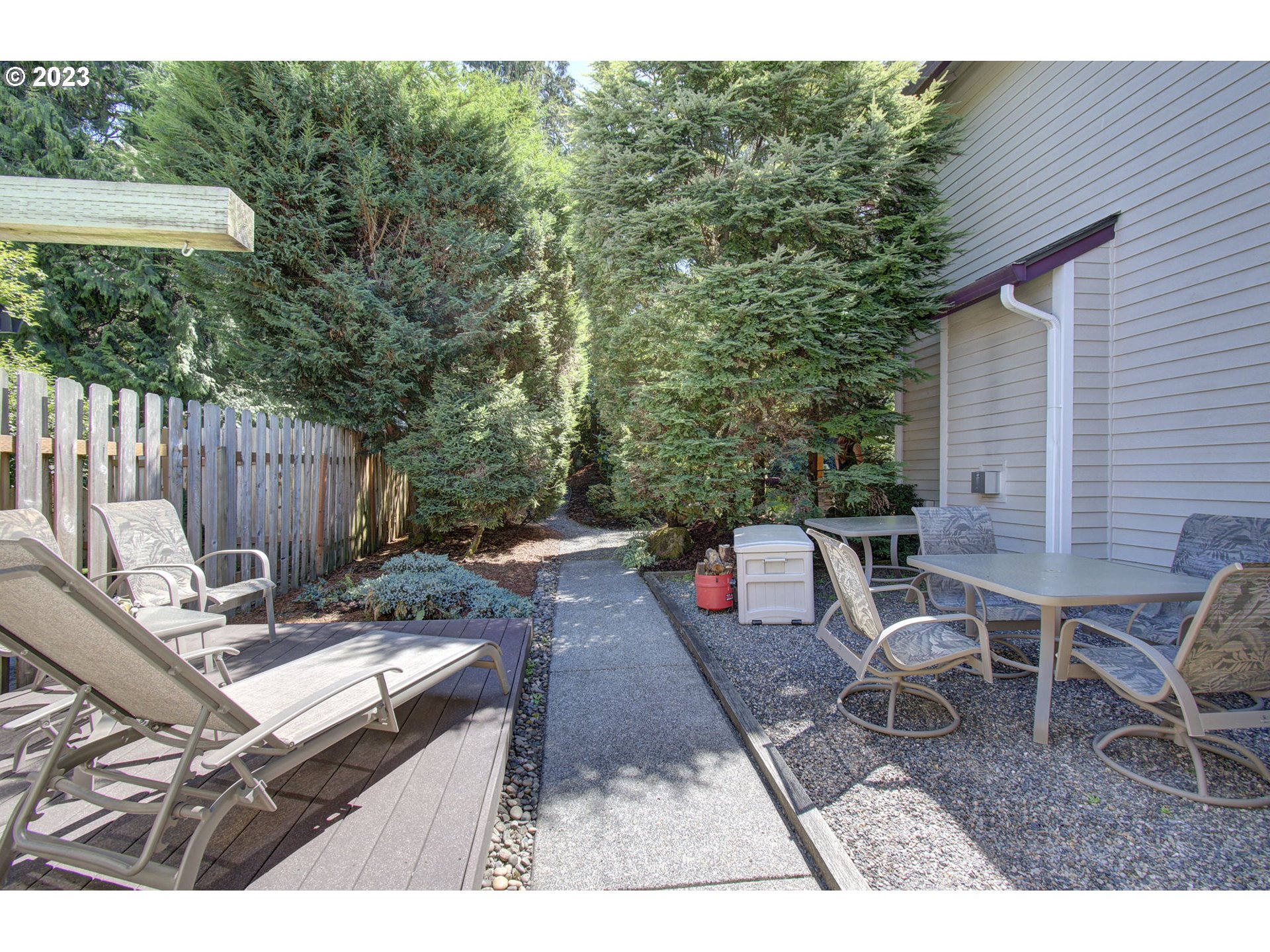 2407 Northeast 165th Street Ridgefield, WA 98642 - Photo 39 of 46 a view of a patio with table and chairs with wooden fence