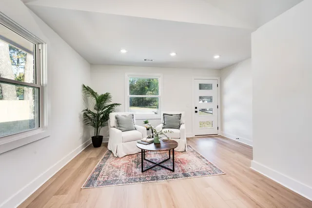 a living room with furniture a wooden floor and a window