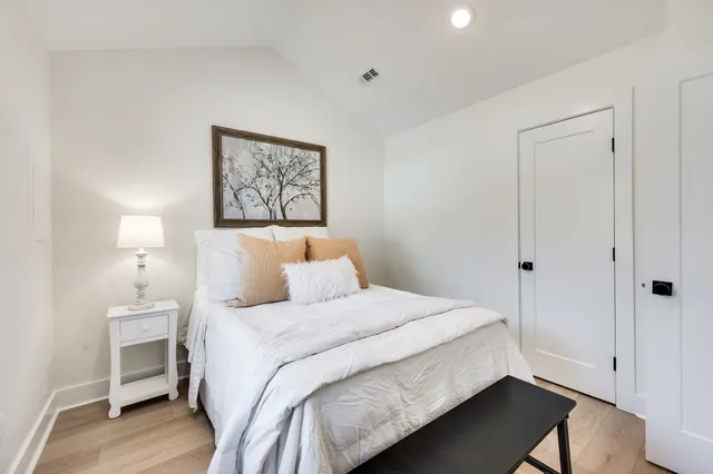 a bedroom with a bed and a lamp