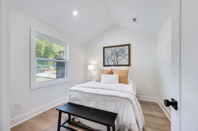 a bedroom with a bed and a window