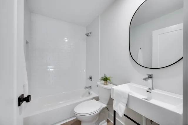 a bathroom with a sink toilet and a mirror