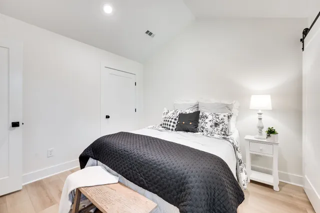 a bedroom with a bed and a lamp