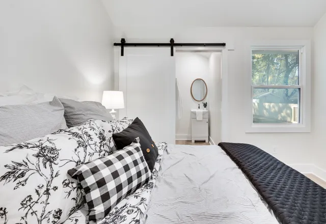 a bedroom with a bed and a window