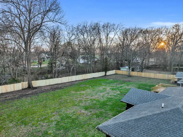 a view of a park with large trees