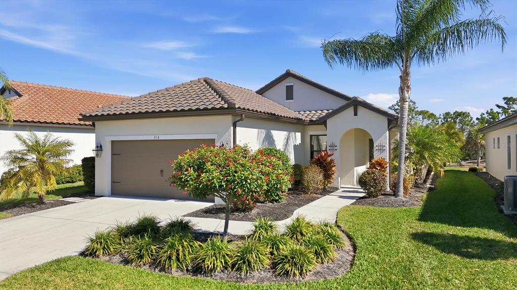 216 Brienza Loop Nokomis, FL 34275 - Photo 1 of 58 a front view of a house with garden