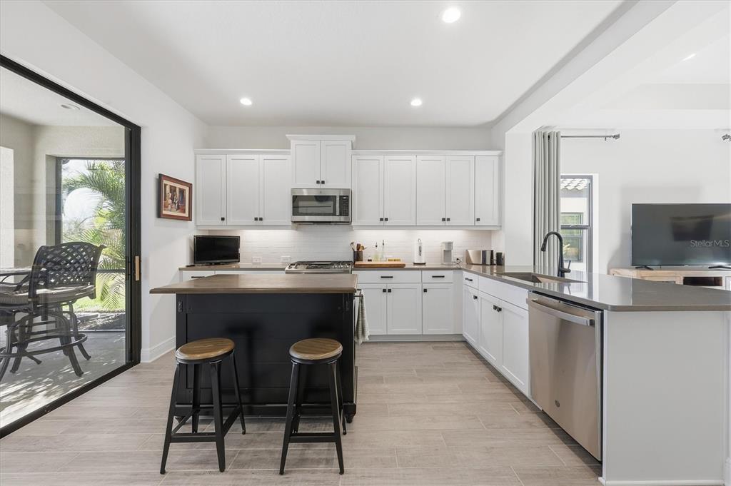 216 Brienza Loop Nokomis, FL 34275 - Photo 15 of 58 a kitchen with stainless steel appliances granite countertop a stove a sink a microwave a refrigerator and cabinets