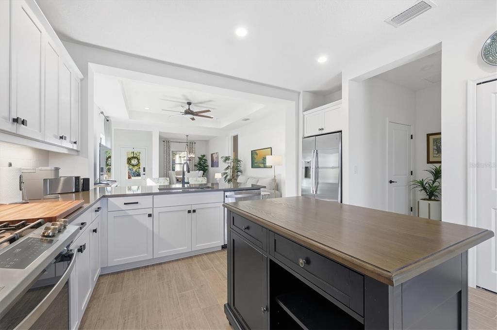 216 Brienza Loop Nokomis, FL 34275 - Photo 17 of 58 a kitchen with a stove a sink and a refrigerator