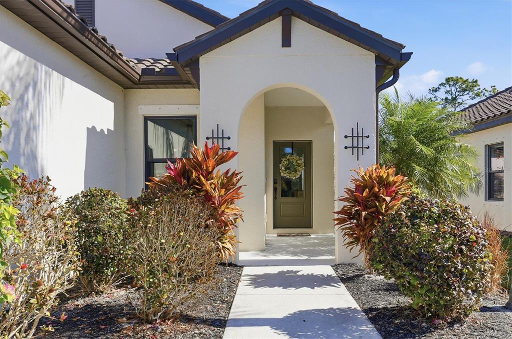 216 Brienza Loop Nokomis, FL 34275 - Photo 5 of 58 a front view of a house with plants