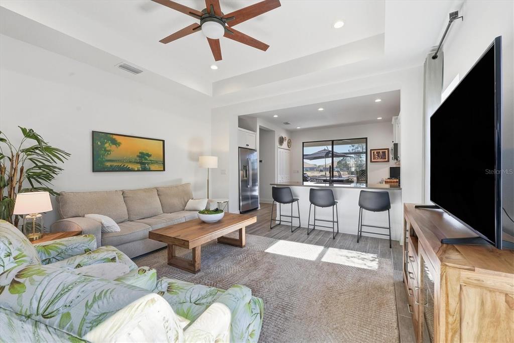 216 Brienza Loop Nokomis, FL 34275 - Photo 7 of 58 a living room with furniture a ceiling fan and a flat screen tv