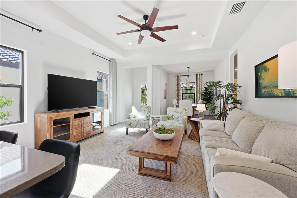 216 Brienza Loop Nokomis, FL 34275 - Photo 9 of 58 a living room with furniture and a flat screen tv