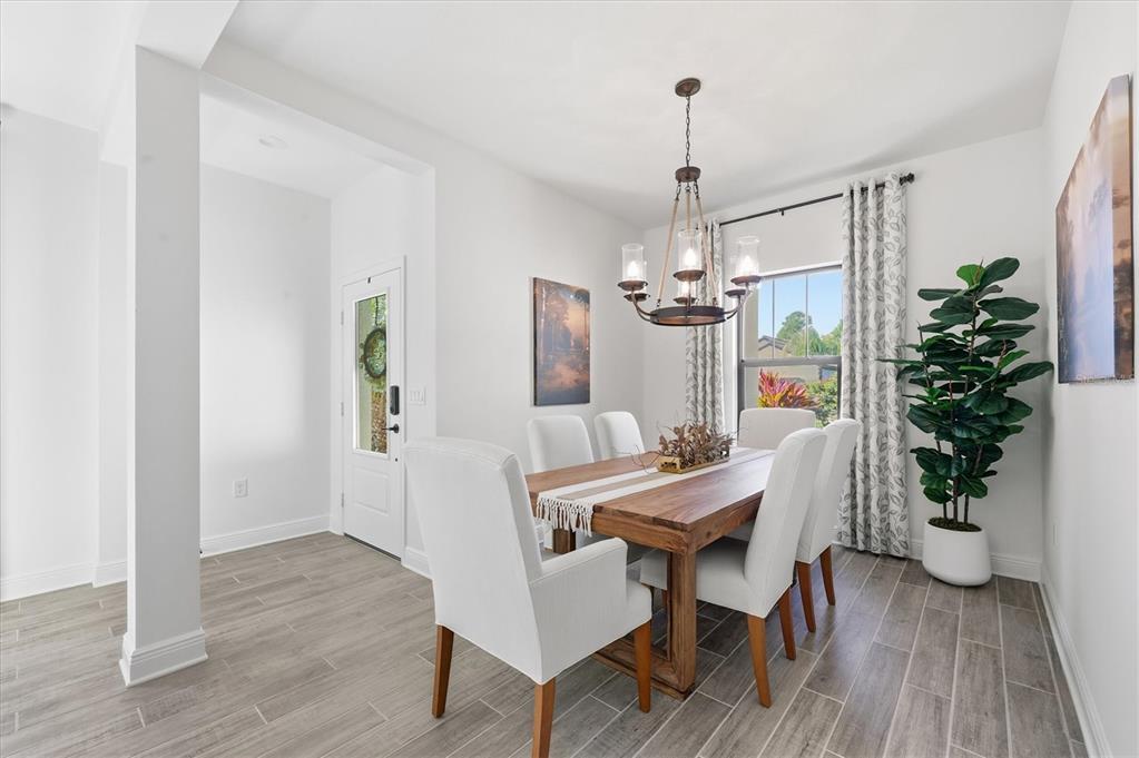 216 Brienza Loop Nokomis, FL 34275 - Photo 10 of 58 a view of a dining room with furniture window and wooden floor