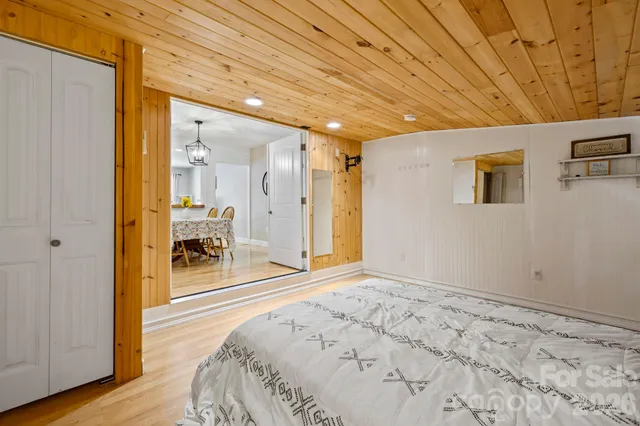 a spacious bedroom with a bed and a table in it