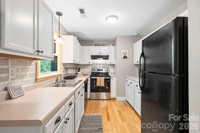 a kitchen with a refrigerator a sink and a stove