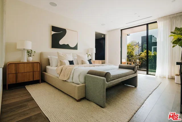 a bedroom with a bed and a painting on the wall