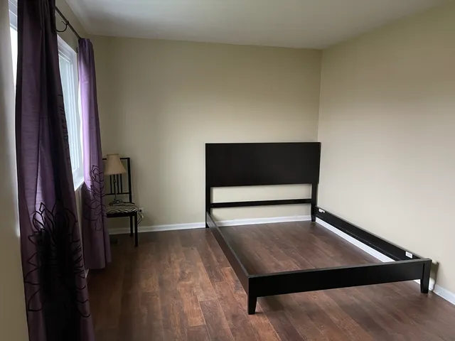 a living room with a bed furniture and a window