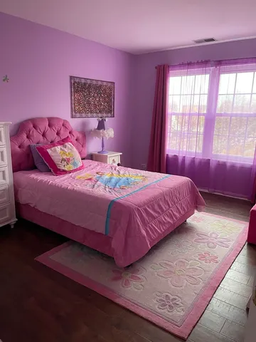 a bedroom with a bed and a couch