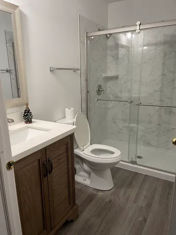 a bathroom with a sink a toilet and shower