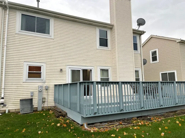 a view of a house with wooden fence
