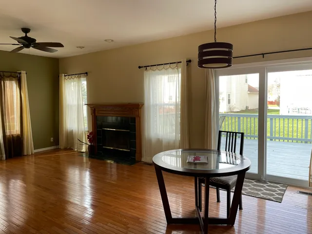 a view of a dining room with furniture window and wooden floor