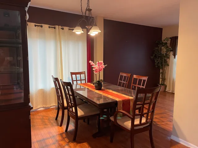 a dining room with furniture and window