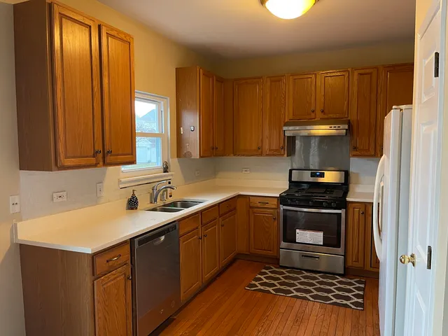 a kitchen with a sink stove and refrigerator
