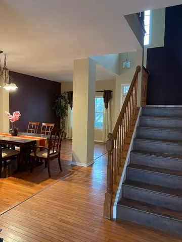 a view of a dining room with furniture and wooden floor