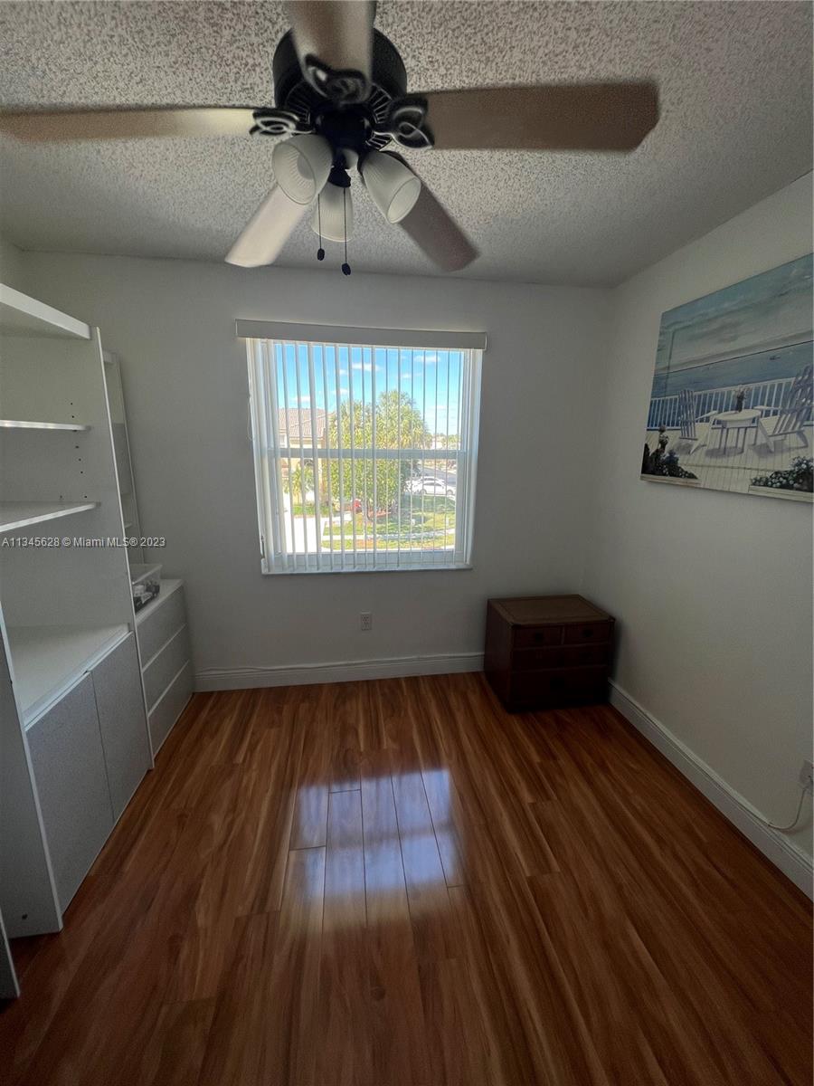 Towngate Pembroke Pines, FL 33028 - Photo 12 of 31 a view of empty room with wooden floor and fan