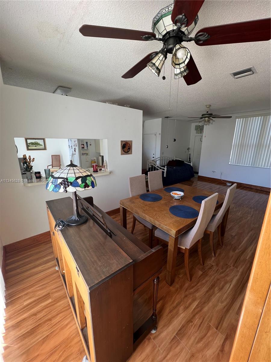 Towngate Pembroke Pines, FL 33028 - Photo 30 of 31 a living room with stainless steel appliances kitchen island granite countertop lots of furniture and a wooden floors
