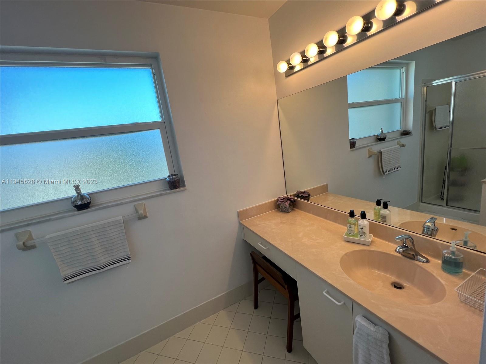 Towngate Pembroke Pines, FL 33028 - Photo 6 of 31 a bathroom with a sink and a mirror