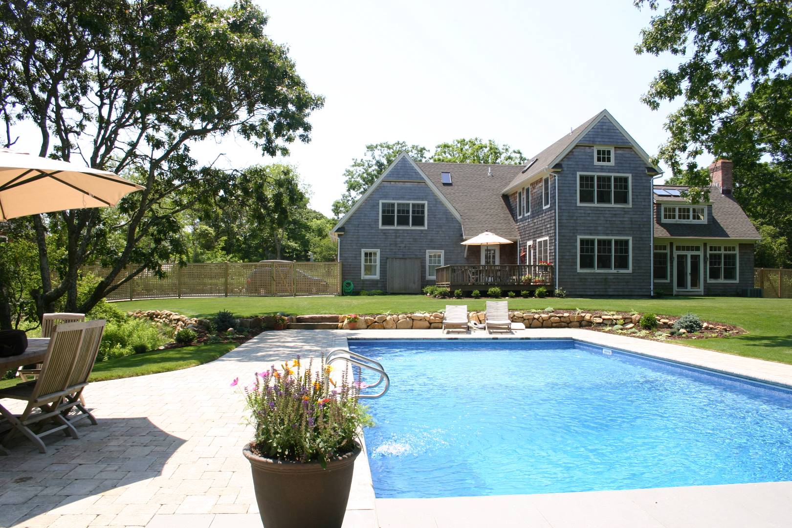 6 Wills Point Road Montauk, NY 11954 - Photo 13 of 16 a front view of a house with swimming pool having outdoor seating