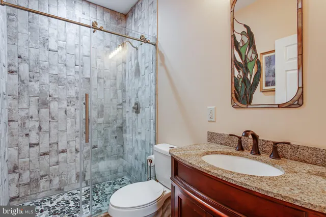 a view of empty room with wooden floor and fireplace