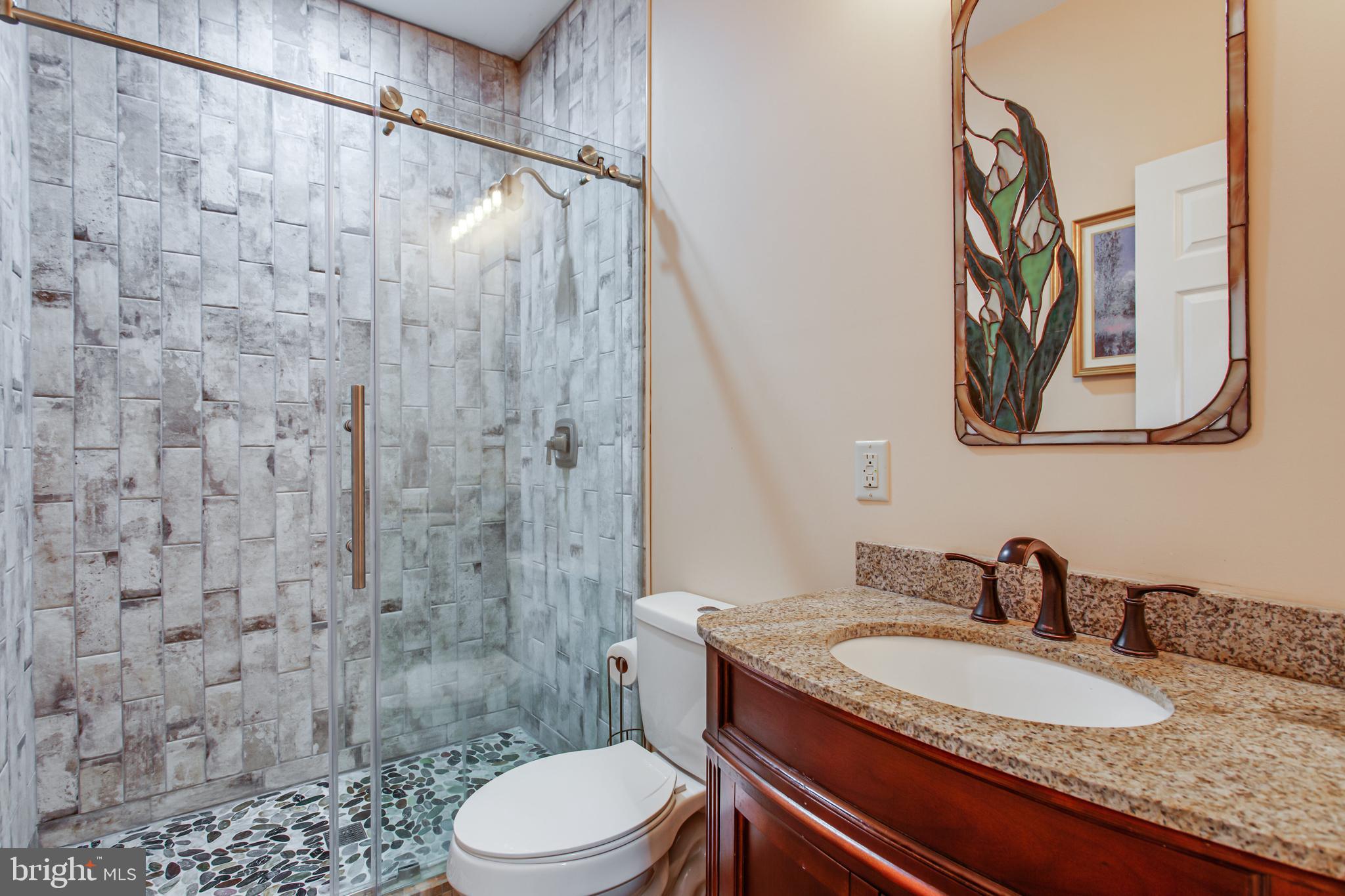 43840 Tarrywyle Way Leonardtown, MD 20650 - Photo 12 of 41 a bathroom with a granite countertop sink toilet and shower