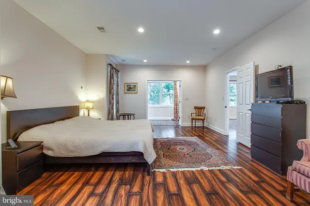 a bathroom with a granite countertop sink and a bathtub