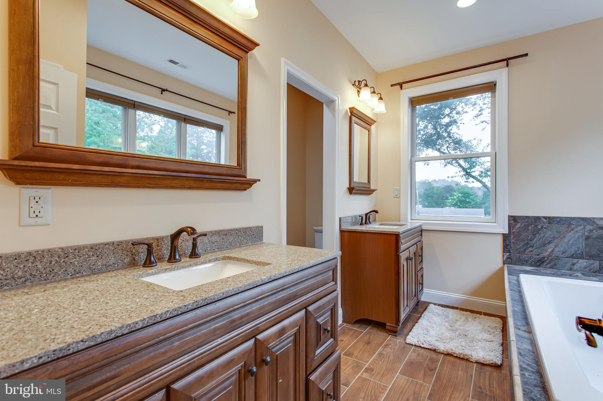 43840 Tarrywyle Way Leonardtown, MD 20650 - Photo 18 of 41 a bathroom with a granite countertop sink and a bathtub