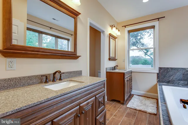 a bathroom with a bathtub and window