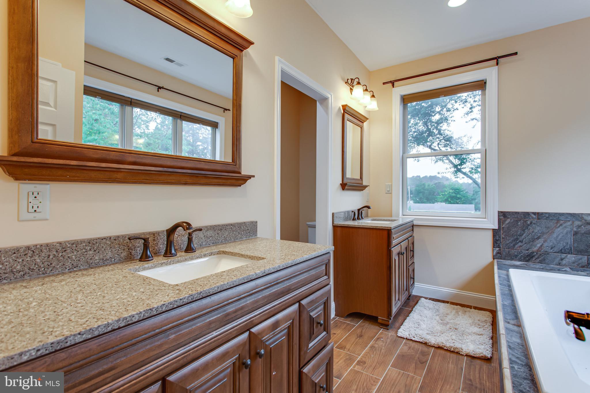 43840 Tarrywyle Way Leonardtown, MD 20650 - Photo 19 of 41 a bathroom with a granite countertop sink and mirror