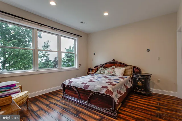 a bedroom with a bed and a large window