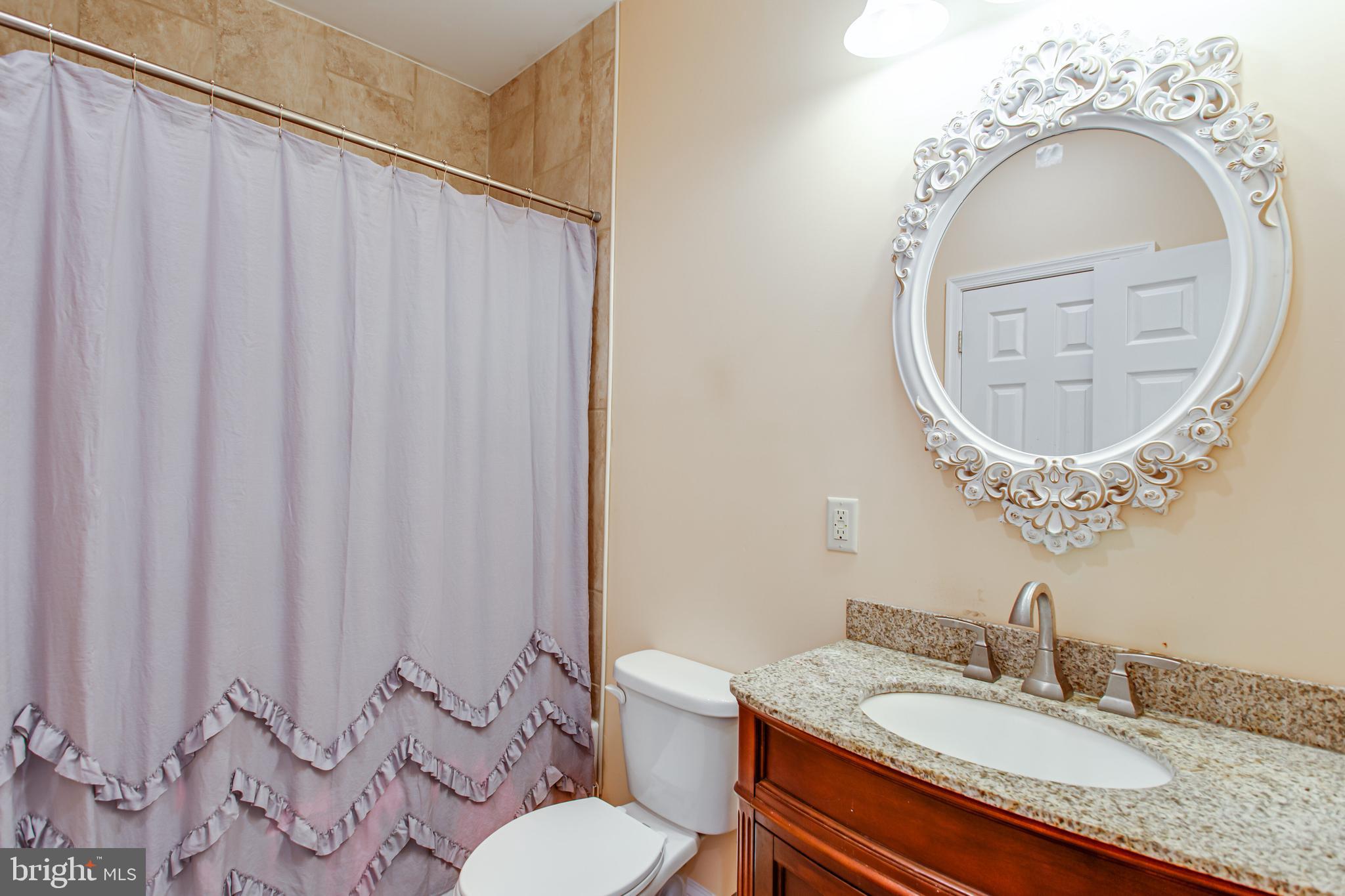 43840 Tarrywyle Way Leonardtown, MD 20650 - Photo 26 of 41 a bathroom with a granite countertop sink and a mirror