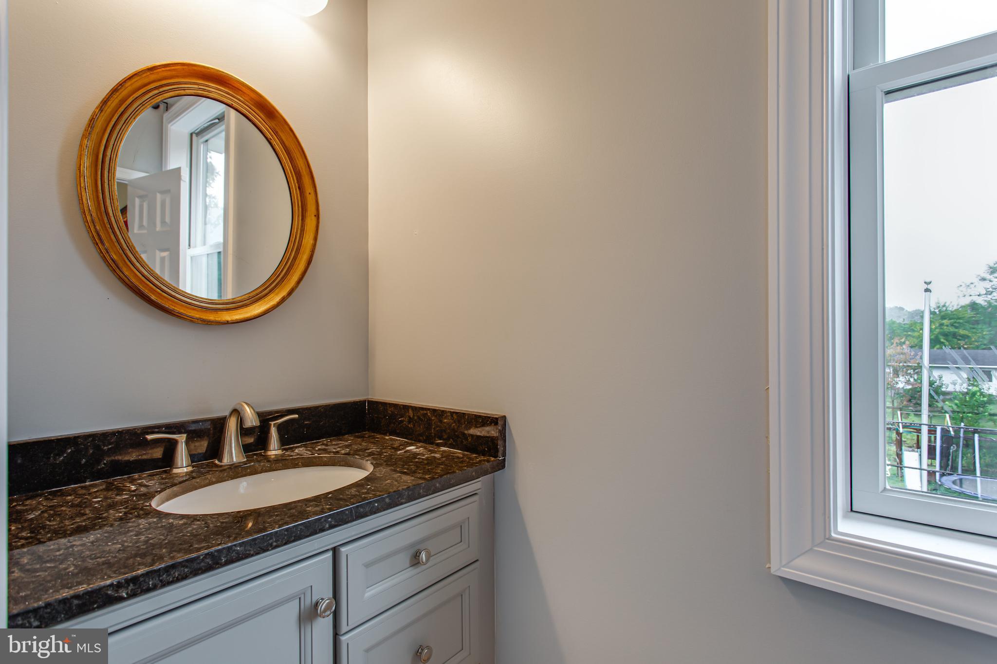 43840 Tarrywyle Way Leonardtown, MD 20650 - Photo 28 of 41 a bathroom with a granite countertop sink and a mirror