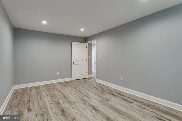 a view of a room with wooden floor