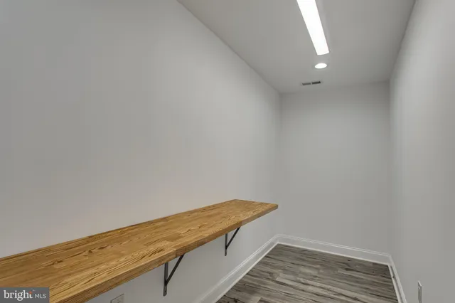 a bathroom with a granite countertop sink a toilet and bathtub