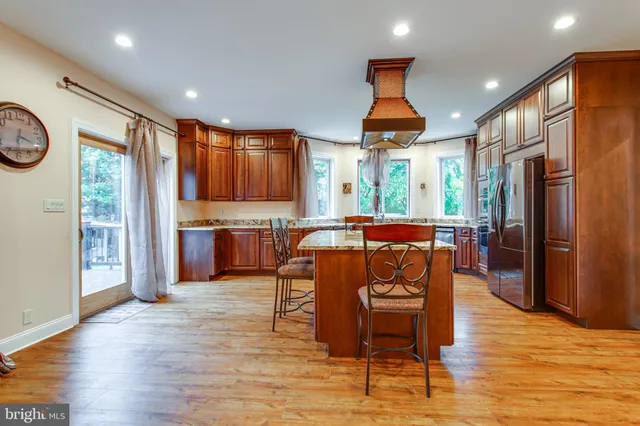a open kitchen with stainless steel appliances granite countertop a stove and refrigerator