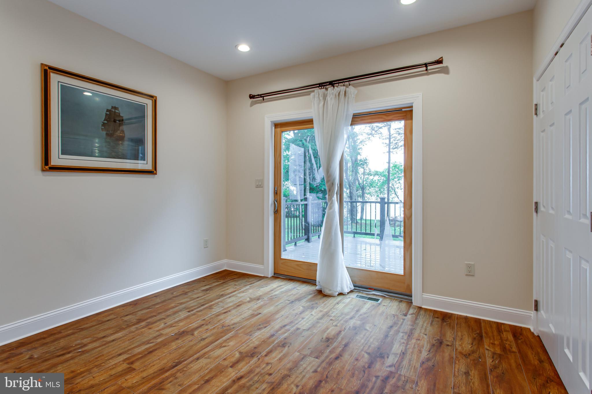 43840 Tarrywyle Way Leonardtown, MD 20650 - Photo 9 of 41 a view of an empty room with wooden floor and a window