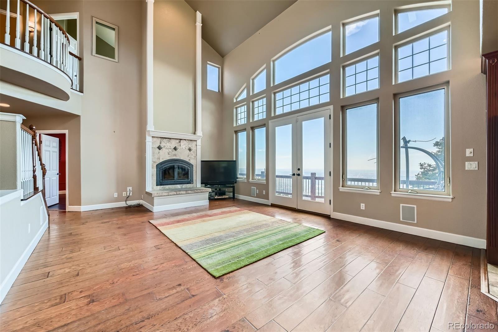 570 Upper Vista Road Manitou Springs, CO 80829 - Photo 14 of 36 a view of an empty room with wooden floor and a window