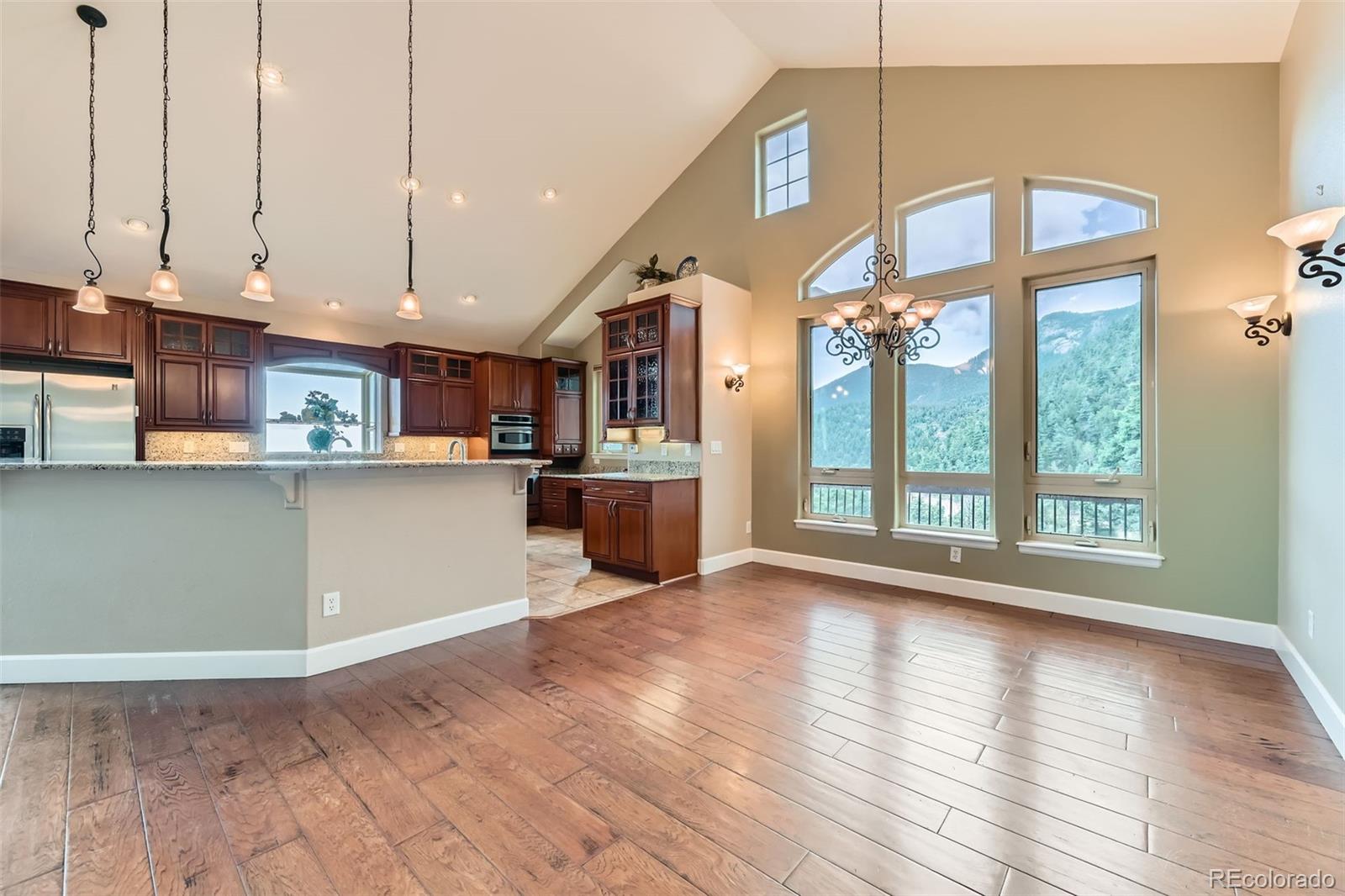 570 Upper Vista Road Manitou Springs, CO 80829 - Photo 16 of 36 a view of a kitchen with furniture and wooden floor