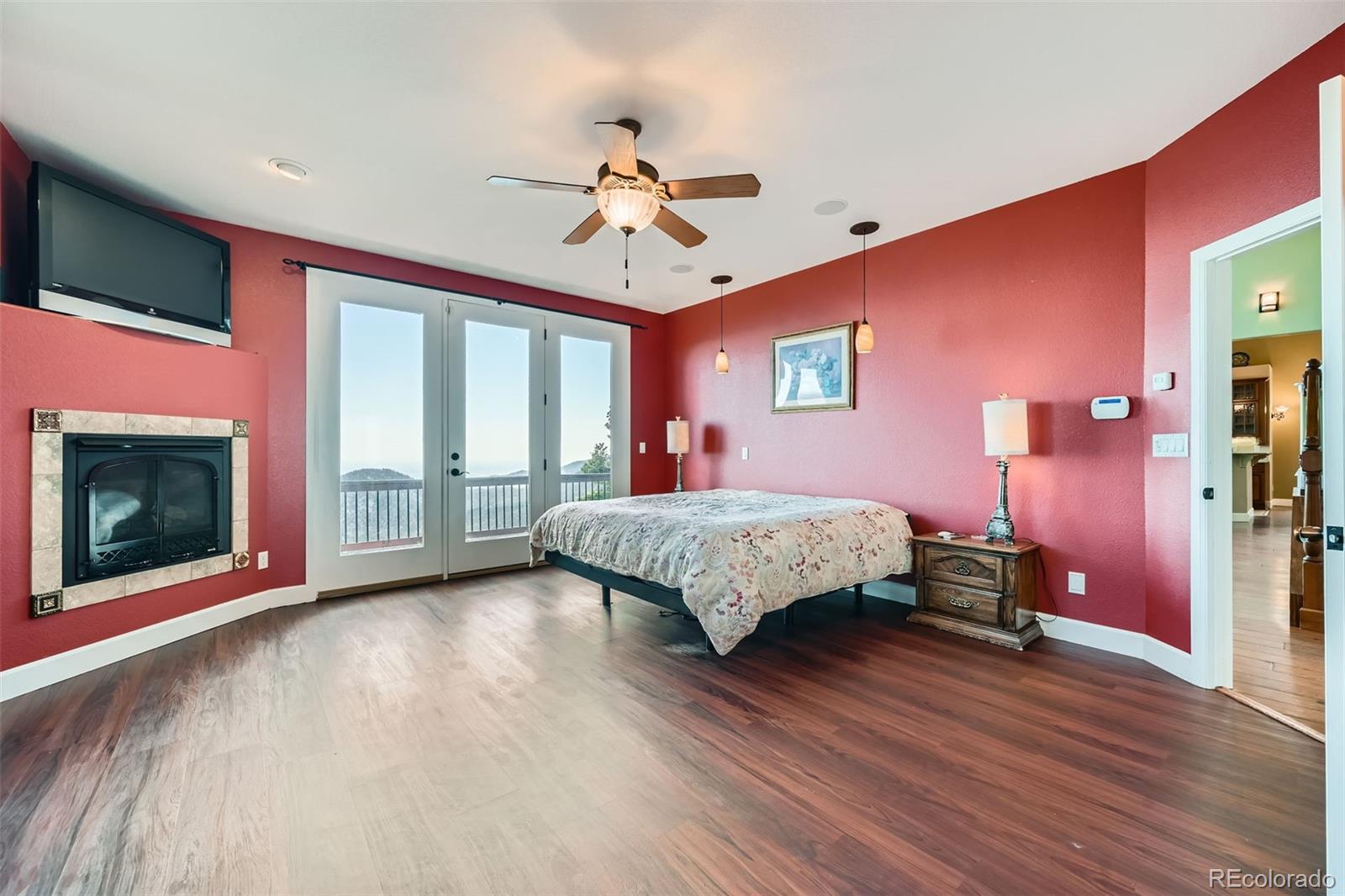 570 Upper Vista Road Manitou Springs, CO 80829 - Photo 20 of 36 a bedroom with a bed and a chandelier