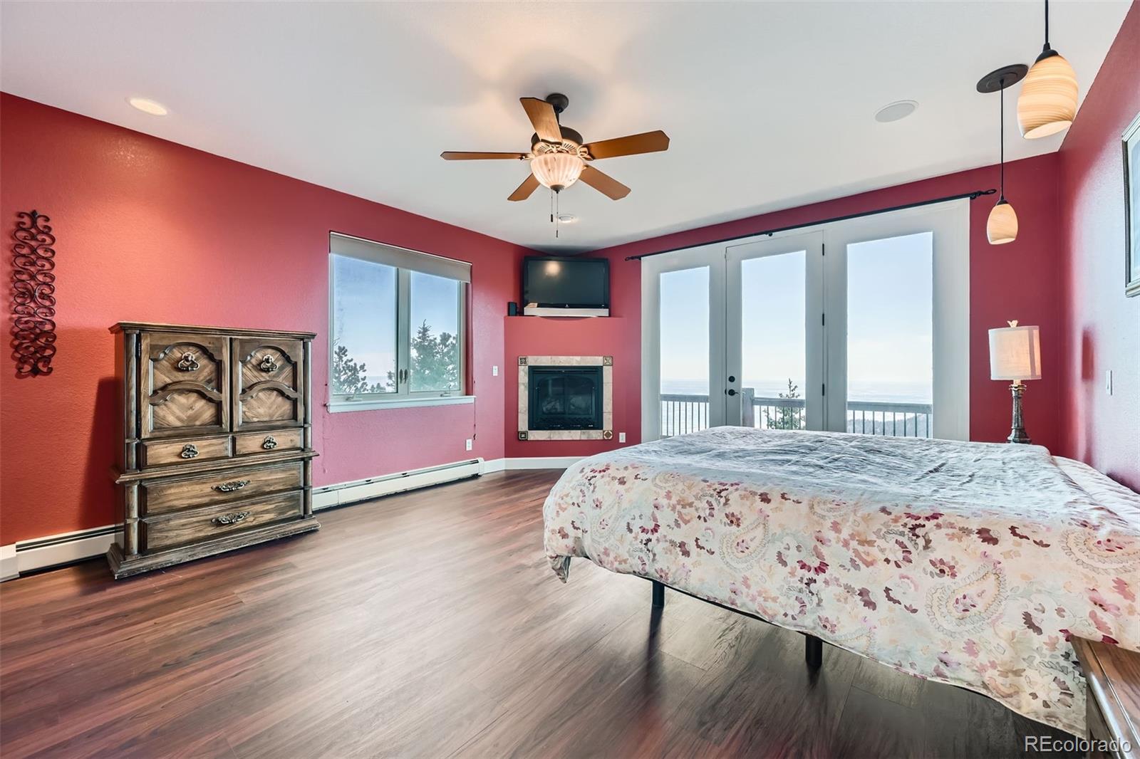 570 Upper Vista Road Manitou Springs, CO 80829 - Photo 21 of 36 a bedroom with a bed and a flat screen tv with dresser