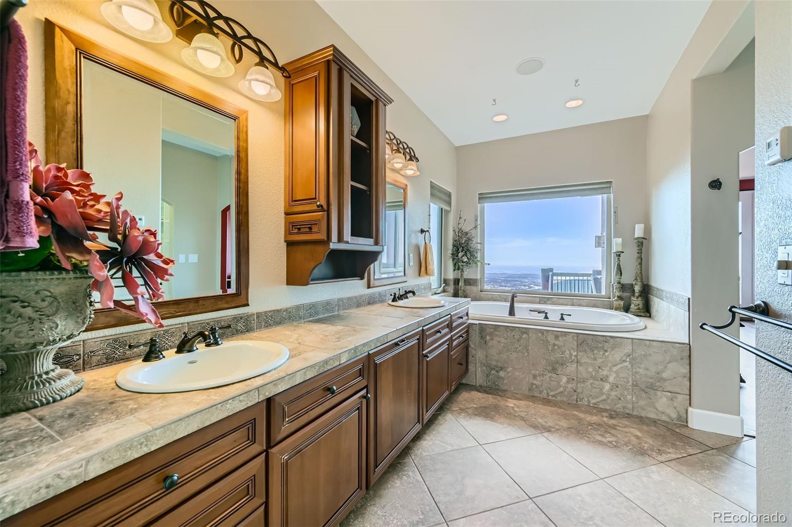 570 Upper Vista Road Manitou Springs, CO 80829 - Photo 23 of 36 a bathroom with a granite countertop sink double vanity and a mirror