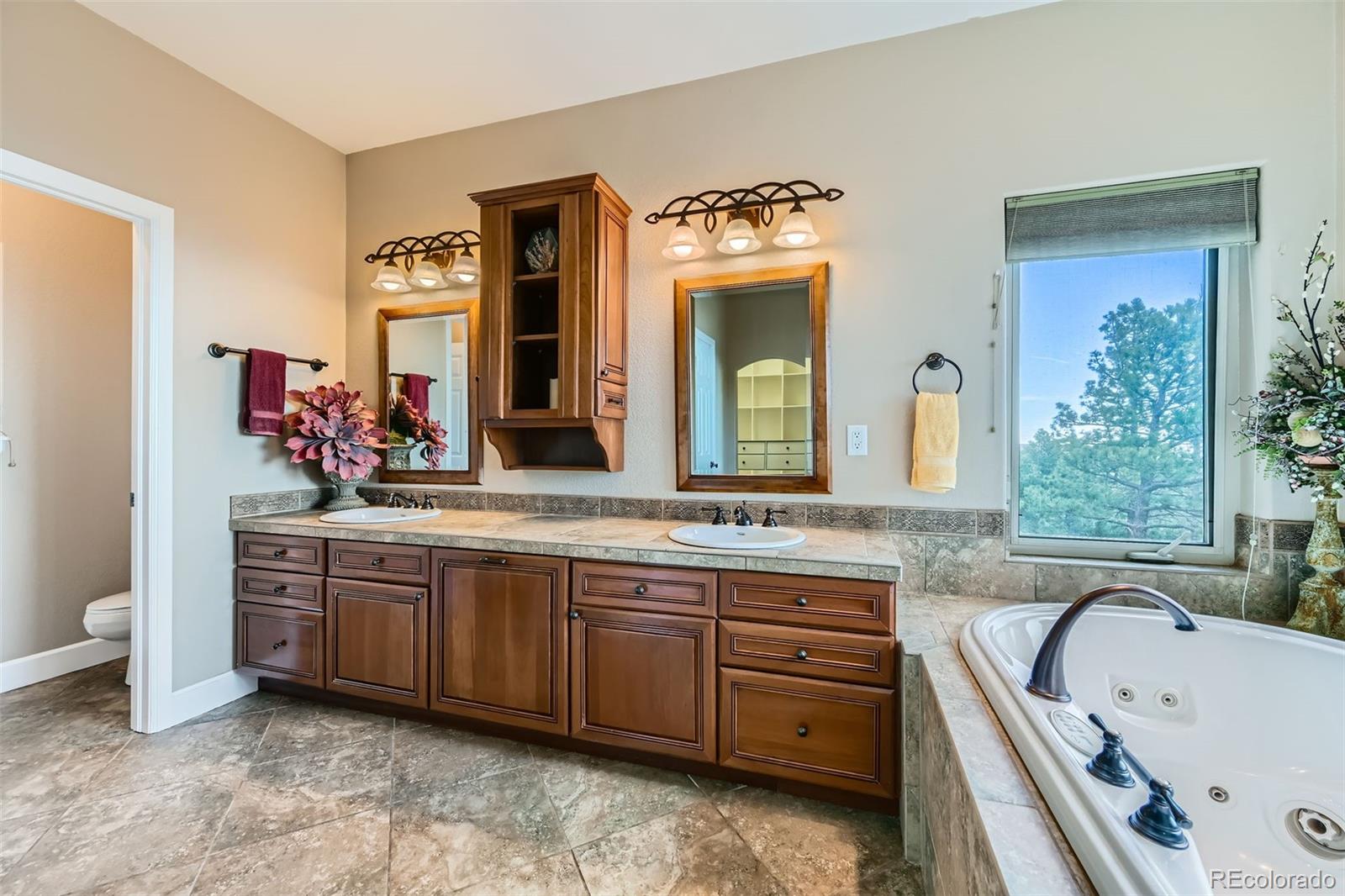570 Upper Vista Road Manitou Springs, CO 80829 - Photo 24 of 36 a spacious bathroom with a tub sink and mirror