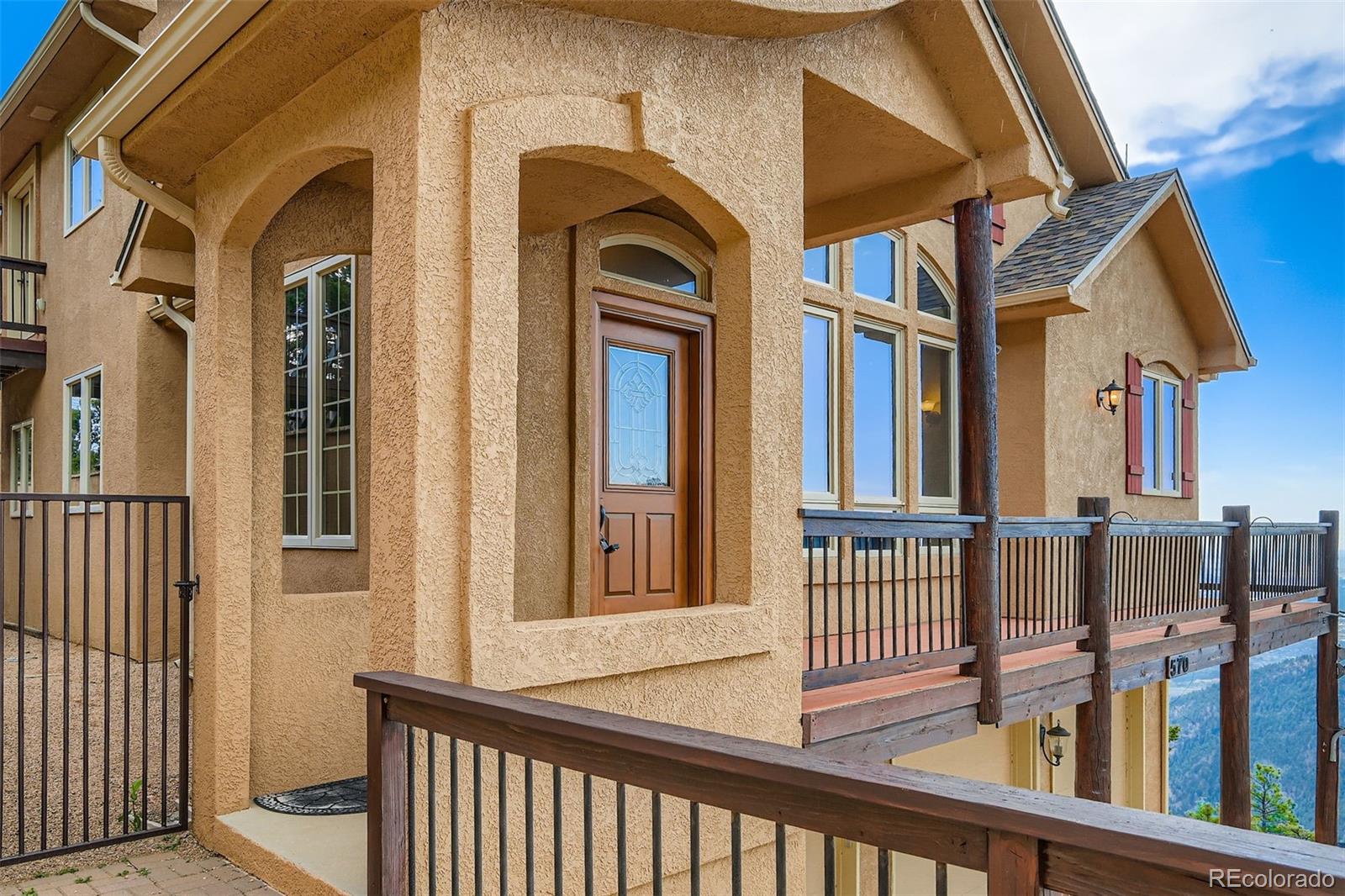 570 Upper Vista Road Manitou Springs, CO 80829 - Photo 5 of 36 a view of a brick house with large windows